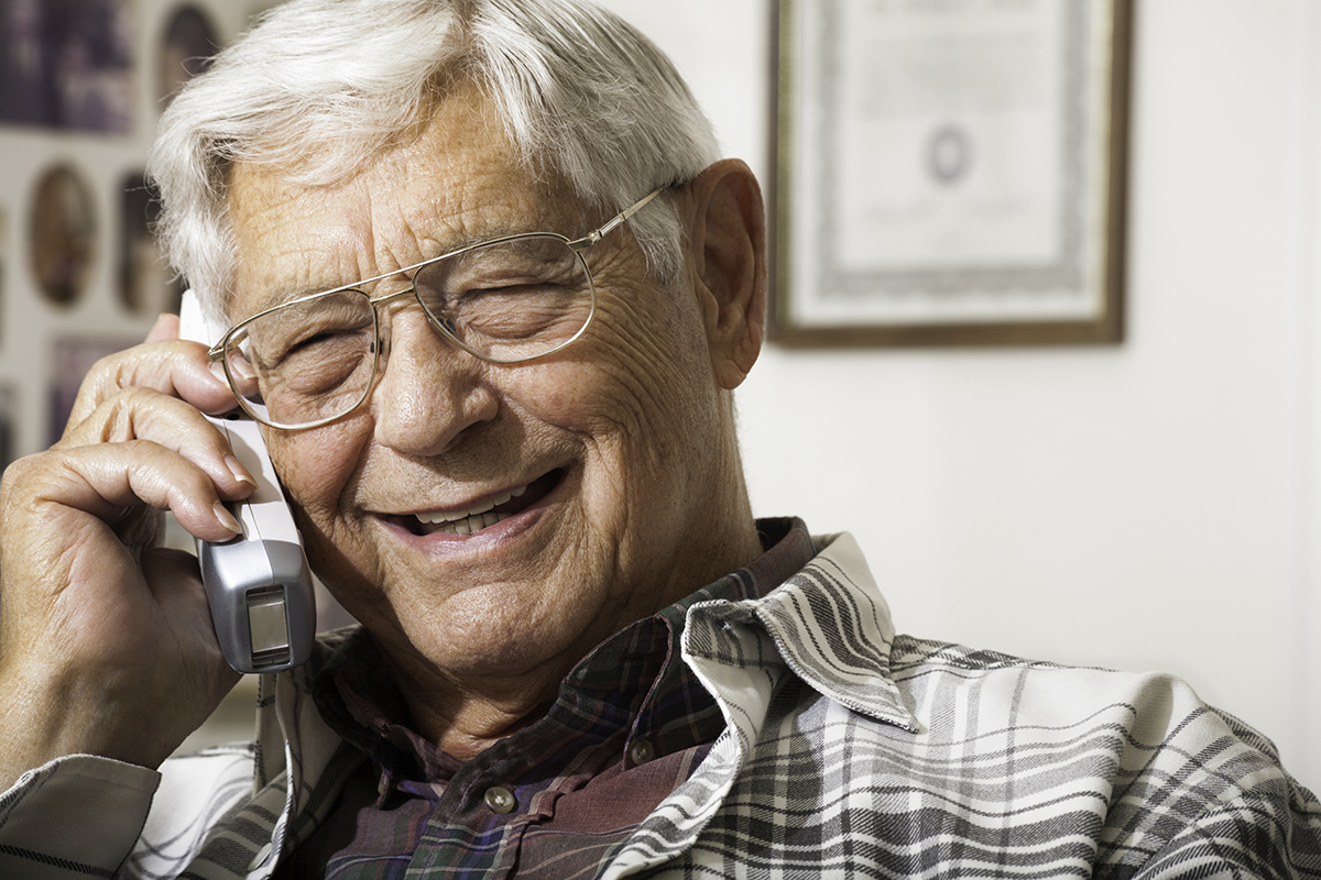 Happy senior man talking on the telephone